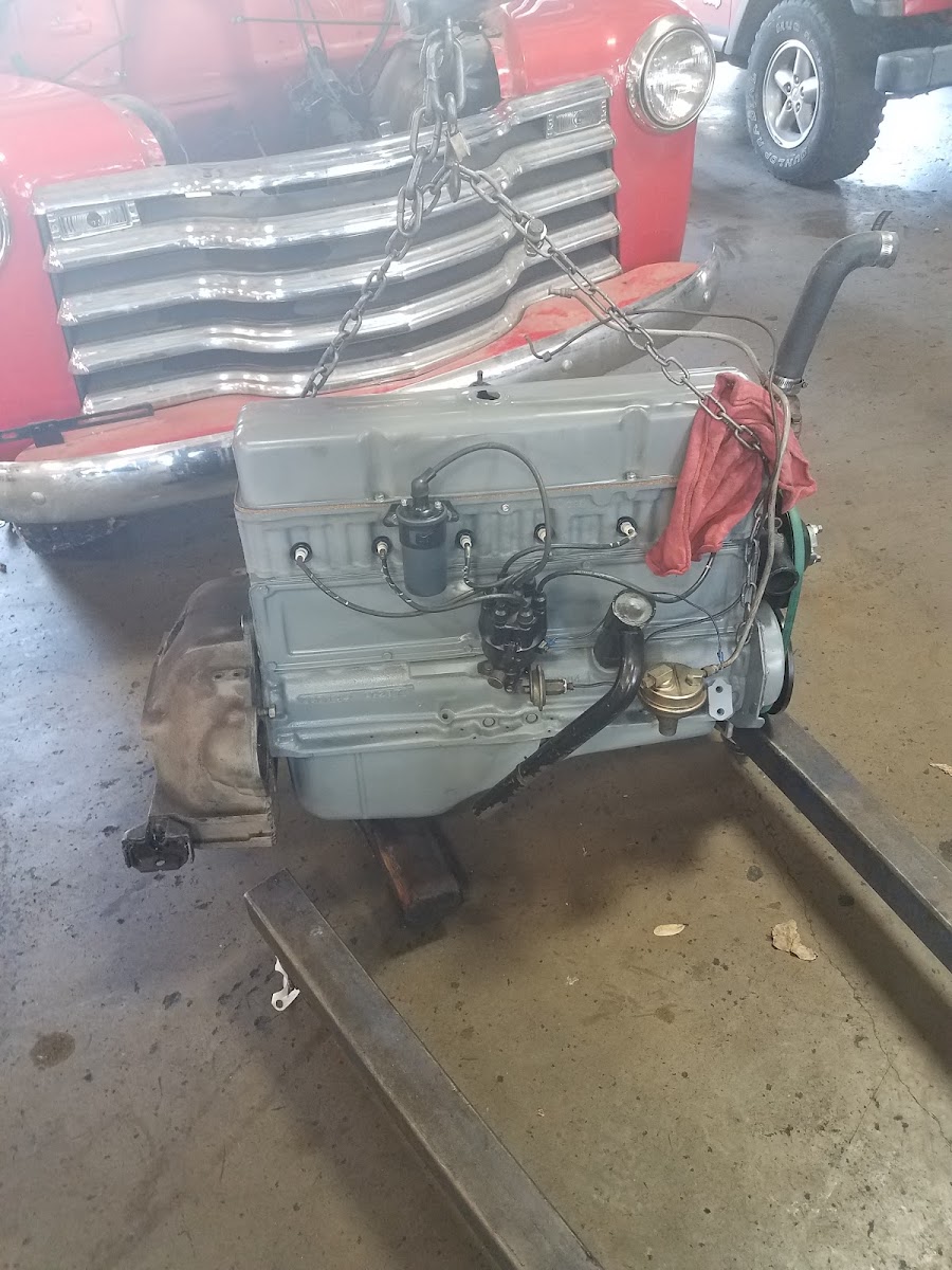 Restored classic engine on stand at Economy Transmission McKinney